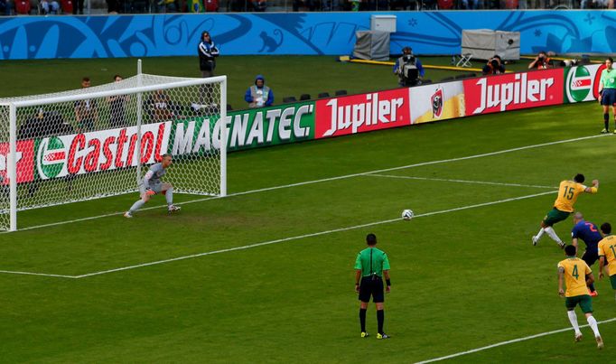 Australia's Mile Jedinak (15) scores a goal from a penalty kick past goalkeeper Jasper Cillessen of the Netherlands during their 2014 World Cup Group B soccer match at th