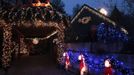 A house decorated with Christmas lights and figurines is lit up in Freising, about 30 km (18.6 miles) north of Munich December 1, 2012. Each year, several home owners set up fairy lights for the year-end holidays. For this particular home, Ulla and Hilmar Haubrich used more than 20,000 lights and 300 empty gift boxes. Picture taken December 1, 2012. REUTERS/Michaela Rehle (GERMANY - Tags: SOCIETY ANNIVERSARY) Published: Pro. 2, 2012, 11:44 dop.