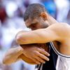 Spurs' Duncan hugs the ball before the Spurs take on the Hea