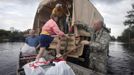 Christine Hopson boards a National Guard truck with family members after their home was flooded in Hurricane Isaac in La Place, Louisiana August 30, 2012. REUTERS/Lee Celano (UNITED STATES - Tags: ENVIRONMENT DISASTER) Published: Srp. 30, 2012, 10:18 odp.