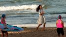 Catherine, Britain's Duchess of Cambridge, runs across Manly beach in Sydney