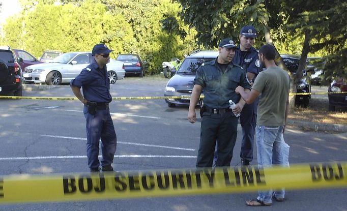 Security personnel stand near security tape after an explosion at Bulgaria's Burgas airport July 18, 2012. At least four people were killed and over 20 injured by an explosion on a bus carrying Israeli tourists outside the airport of the coastal city of Burgas on Wednesday, Bulgarian authorities said. The mayor of the city, on Bulgaria's Black Sea coast, said the bus was carrying Israeli tourists, but police could not immediately confirm their nationality. Police said several other buses at the site had been damaged. REUTERS/Impact Press Group (BULGARIA - Tags: DISASTER TRANSPORT)