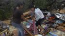 Residents retrieve their belongings after their house was destroyed by a fallen tree caused by Typhoon Bopha in Cagayan de Oro City, southern Philippines December 4, 2012. At least 34 people, mostly soldiers, were killed after flash flood struck a military temporary command post in New Bataan, Compostela Valley, local media reported. REUTERS/Stringer (PHILIPPINES - Tags: DISASTER ENVIRONMENT SOCIETY) Published: Pro. 4, 2012, 12:50 odp.