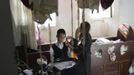 Esther Kreus (R), 13, twirls her brother's side-locks during the family's preparations for the Jewish Sabbath in Jerusalem's Mea Shearim neighbourhood June 29, 2012. The Kreus family are a member of Neturei Karta, a fringe ultra-Orthodox movement within the anti-Zionist bloc. The ultra-Orthodox Jews have gone from being a tiny minority in Israel's mostly secular society to its fastest-growing sector, now about 10 percent of the 7.8 million population. They are exempt from military duty in Israel but draft deferments and state subsidies for the ultra-Orthodox have become a divisive political issue in Israel, where the government must decide a new law by August to ensure more of them do military service. Picture taken June 29, 2012. REUTERS/Ronen Zvulun (JERUSALEM - Tags: RELIGION POLITICS MILITARY TPX IMAGES OF THE DAY) ATTENTION EDITORS - PICTURE 1 OF 21 FOR PACKAGE "ISRAEL'S ULTRA-ORTHODOX". SEARCH "ULTRA-ORTHODOX" FOR ALL PICTURES Published: Čec. 6, 2012, 9:59 dop.