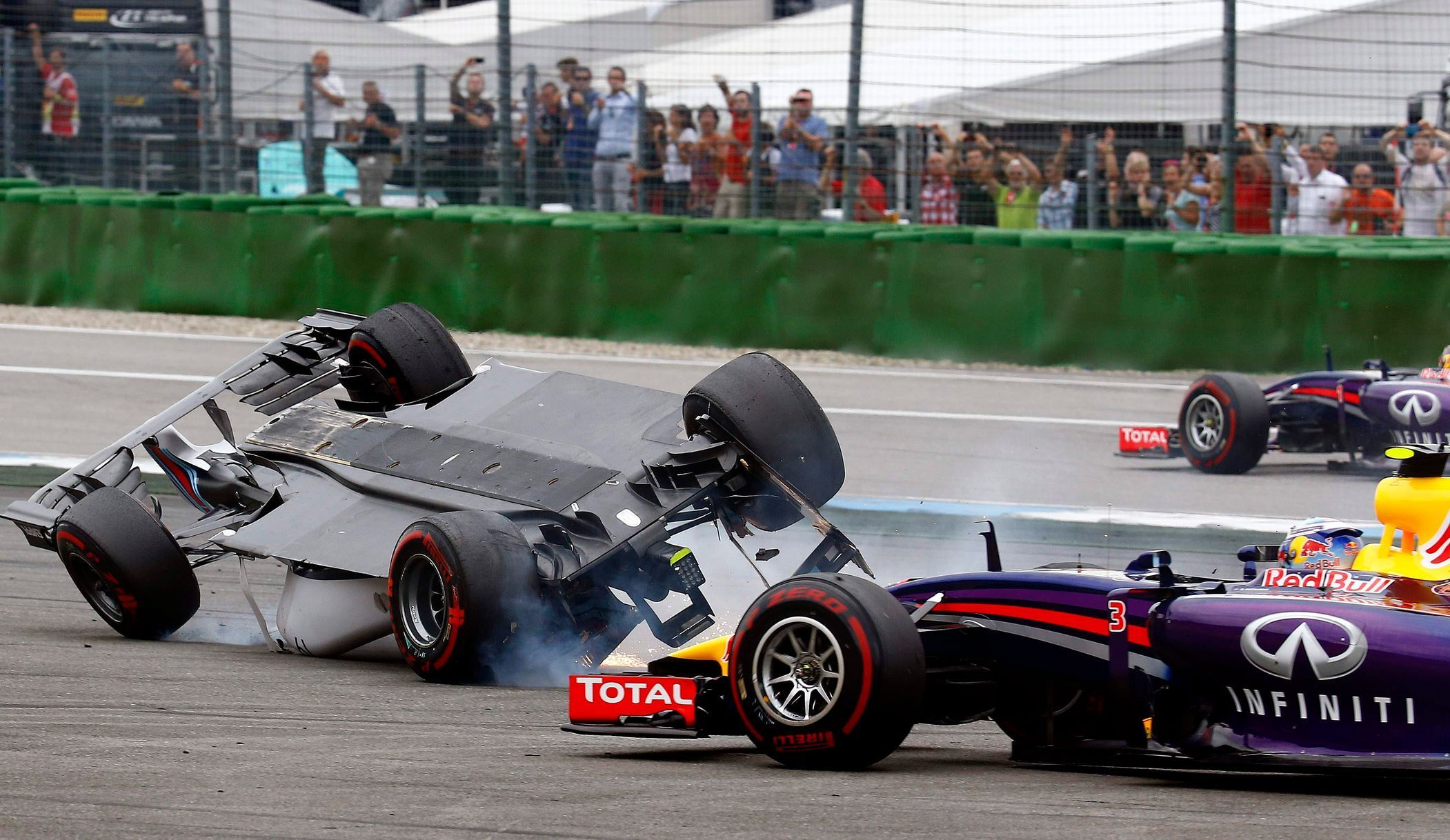 Williams Formula One driver Massa of Brazil crashes with his car in the first corner as Red Bull driver Rocciardo avoids a crash after the start of the German F1 Grand Prix at the Hockenheim racing ci