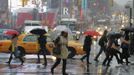 People walk through the wind and snow at New York's Times Square, November 7, 2012. A wintry storm dropped snow on the Northeast and threatened to bring dangerous winds and flooding to a region still climbing out from the devastation of superstorm Sandy. REUTERS/Brendan McDermid (UNITED STATES - Tags: DISASTER ENVIRONMENT) Published: Lis. 7, 2012, 8:23 odp.