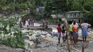 Residents of Kingston try to cross the Hope River after a bridge was washed out by Hurricane Sandy, October 25, 2012. Strengthening rapidly after tearing into Jamaica and crossing the warm Caribbean Sea, Sandy hit southeastern Cuba early on Thursday with 105-mph winds that cut power and blew over trees, with at least three fatalities in Jamaica and Haiti. REUTERS/Gilbert Bellamy (JAMAICA - Tags: ENVIRONMENT DISASTER) Published: Říj. 25, 2012, 5:52 odp.