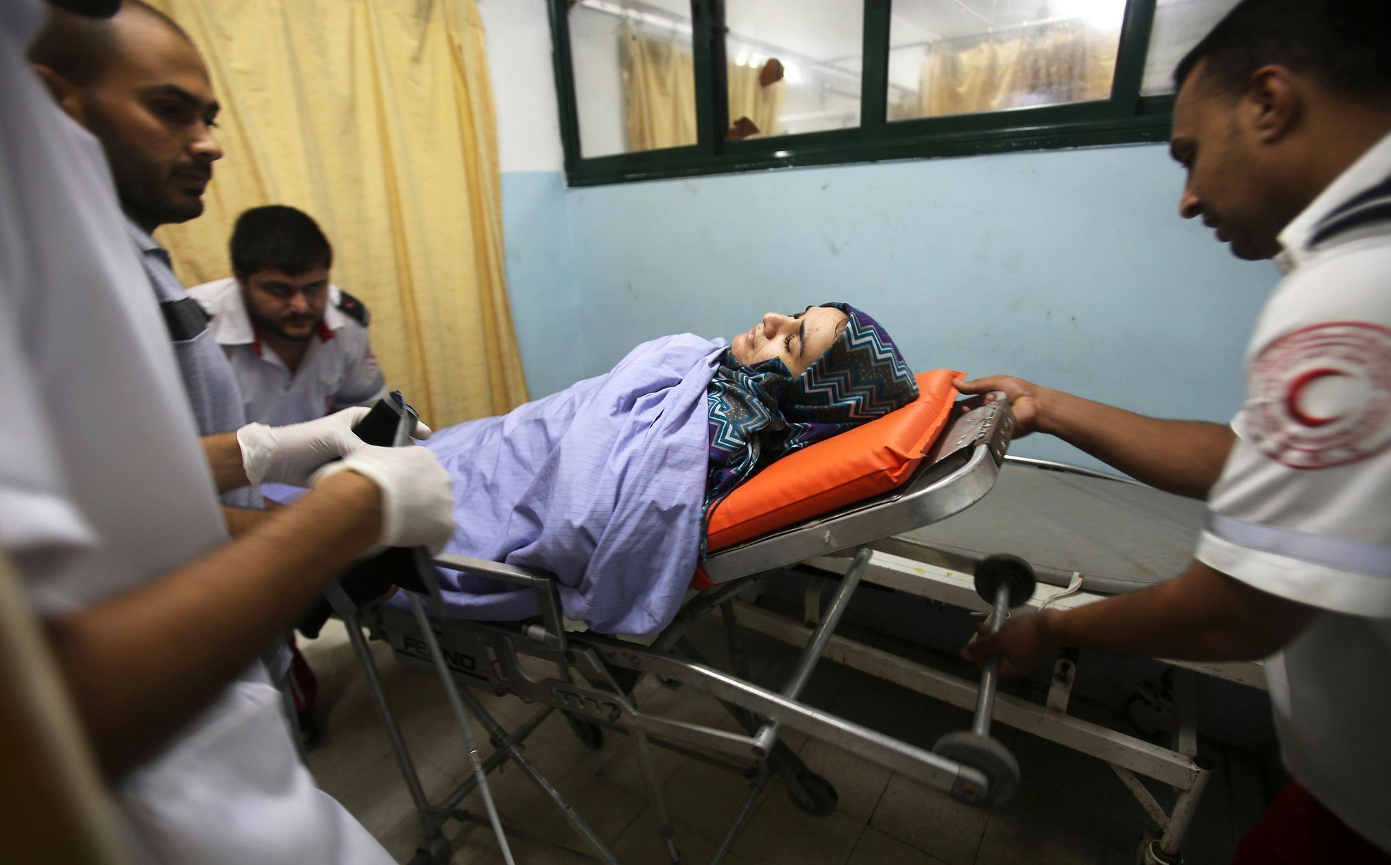 Palestinian woman who, medics said, was wounded in an Israeli air strike arrives at a hospital in Khan Younis in the southern Gaza Strip