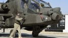 Britain's Prince Harry (R partially obscured) sits in the cockpit of an Apache helicopter in Camp Bastion, southern Afghanistan in this photograph taken November 1, 2012, and released January 21, 2013. The Prince, who is serving as a pilot/gunner with 662 Squadron Army Air Corps, is on a posting to Afghanistan that runs from September 2012 to January 2013. Photograph taken November 1, 2012. Photograph pixelated at source. REUTERS/John Stillwell/Pool (AFGHANISTAN - Tags: MILITARY POLITICS SOCIETY ROYALS CONFLICT) Published: Led. 21, 2013, 8:06 odp.