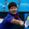Luksika Kumkhum of Thailand hits a return to Mona Barthel of Germany during their women's singles match at the Australian Open 2014 tennis tournament in Melbourne