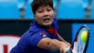 Luksika Kumkhum of Thailand hits a return to Mona Barthel of Germany during their women's singles match at the Australian Open 2014 tennis tournament in Melbourne January