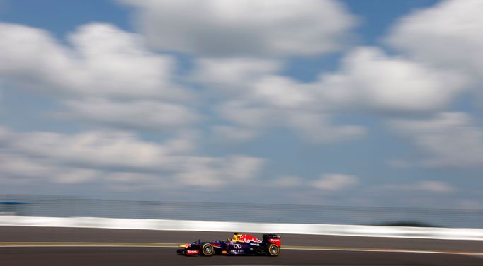 Red Bull Formula One driver Sebastian Vettel of Germany drives under a blue sky and white clouds during the third practice session of the German F1 Grand Prix at the Nuer