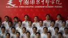 Trainees pose for a group photo after finishing a training course at the communist party school called China Executive Leadership Academy of Pudong in Shanghai, September 24, 2012. China's Communist Party has dramatically stepped up its training of the country's roughly 40 million party and government officials in the past decade. With public scrutiny of cadre behaviour growing via social media, the party is likely to call for continued, and deepened, cadre education at the upcoming 18th Party Congress. At the vanguard of this education drive, alongside a Central Party School in Beijing, are three "Executive Leadership Academies" which opened in 2005 for middle-ranking and senior officials in Shanghai, Yan'an and Jinggangshan. The curriculum covers Marxism, Leninism and Mao Zedong Thought, but students may also take finance courses, receive in-depth media training or role-play crisis management scenarios on everything from disease outbreaks to train wrecks. REUTERS/Carlos Barria (CHINA - Tags: POLITICS SOCIETY) Published: Zář. 24, 2012, 2:07 odp.