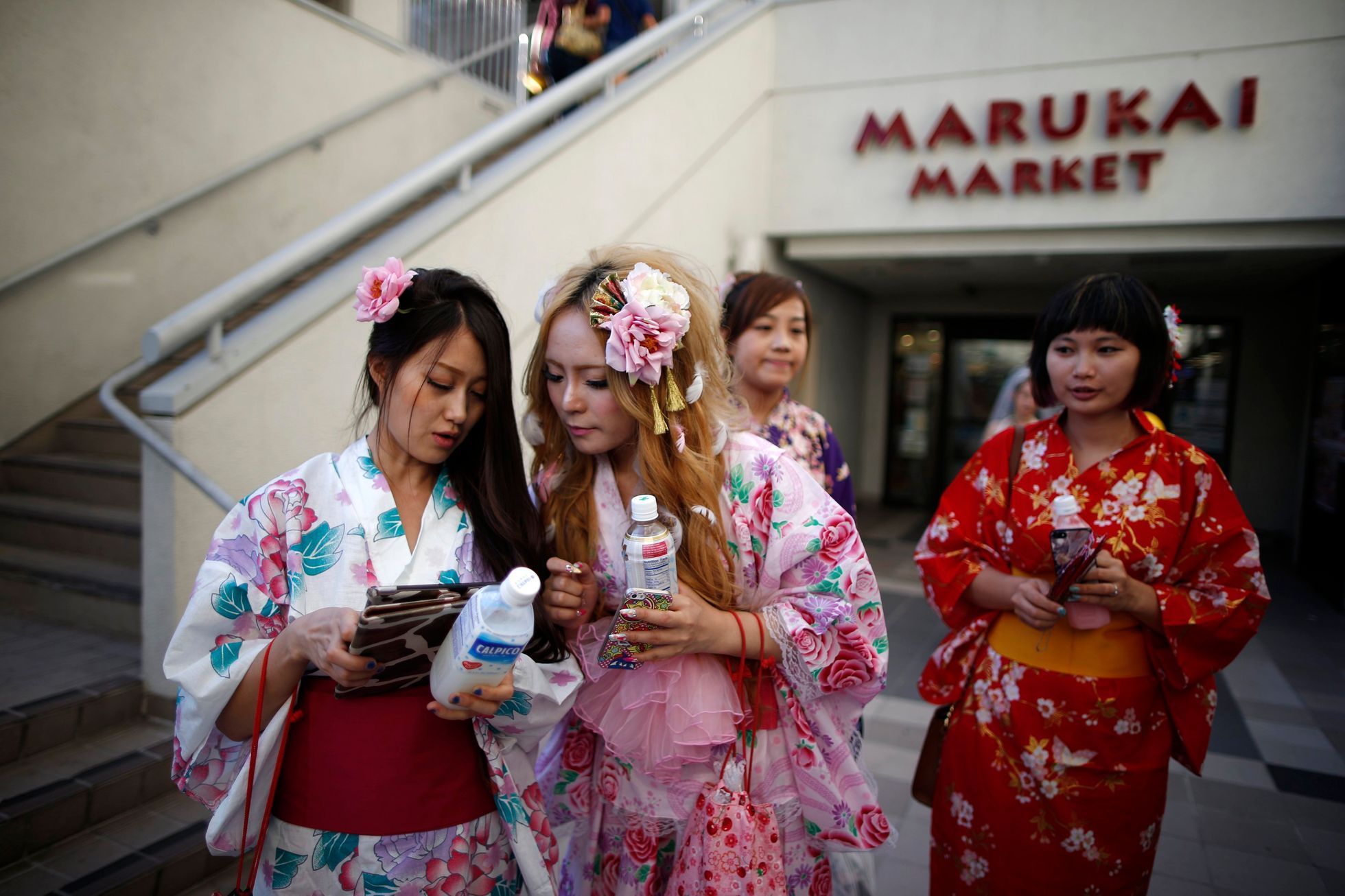 People walk out of a Japanese supermarket in the Little Tokyo area of Los Angeles