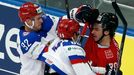 Russia's Alexander Burmistrov (C) and Yevgeni Kuznetsov (L) clash with Switzerland's Denis Hollenstein (R) during their men's ice hockey World Championship Group B game a