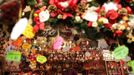 A woman stands in a stand in a traditional Christmas market in downtown Rome December 4 , 2012. REUTERS/Tony Gentile (ITALY - Tags: SOCIETY) Published: Pro. 4, 2012, 2:20 odp.