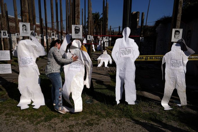 A volunteer places a human silhouette in memory of detained and missing people at Jose Domingo Canas memorial house, a former detention, torture and forced disappearance