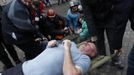 Anti-government protesters carry an injured man on a stretcher to medical staff after clashes with riot police in Independence Square in Kiev February 20, 2014. Ukrainian