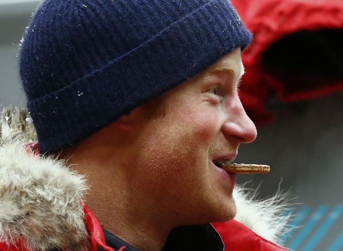 Britain's Prince Harry eats a biscuit after a cold chamber training exercise with the Walking with the Wounded South Pole Allied Challenge 2013 British team at Nuneaton in central England