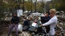 Teresa Echevarria holds her son Ezequiel next to her daughter Maria as they wait for a bulldozer to demolish two homes at the Spanish gypsy settlement of Puerta de Hierro, in the outskirts of Madrid November 20, 2012. Fifty-four families have been living in Puerta de Hierro, on the banks of the Manzanares river for over 50 years. Since the summer of 2010, the community has been subject to evictions on the grounds that the dwellings are illegal. Families, whose homes have been demolished, move in with relatives whose houses still remain while the debris keeps piling up around them as more demolitions take place. REUTERS/Susana Vera (SPAIN - Tags: CIVIL UNREST BUSINESS CONSTRUCTION) Published: Lis. 20, 2012, 4:43 odp.