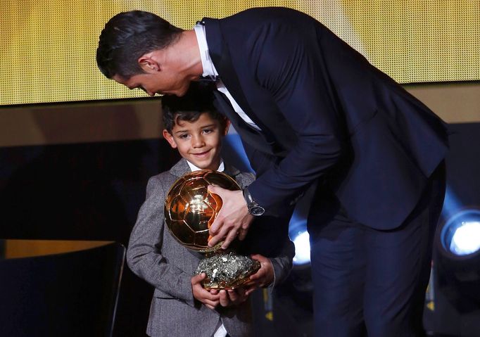 Real Madrid's Cristiano Ronaldo of Portugal, stands with his son Cristiano Ronaldo Jr, after winning the FIFA Ballon d'Or 2014 during the soccer awards ceremony at the Ko