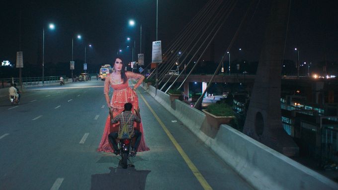 Na snímku z Joylandu hrdina Haider veze na motorce večerním městem obří podobiznu Biby, která má viset jako reklama na divadelní show.