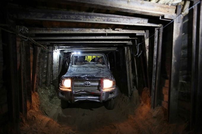 Palestinian workers ride a four-wheel vehicle inside a huge tunnel for smuggling cars and spare parts beneath the border between Egypt and southern Gaza Strip in Rafah . by Wissam Nassar.