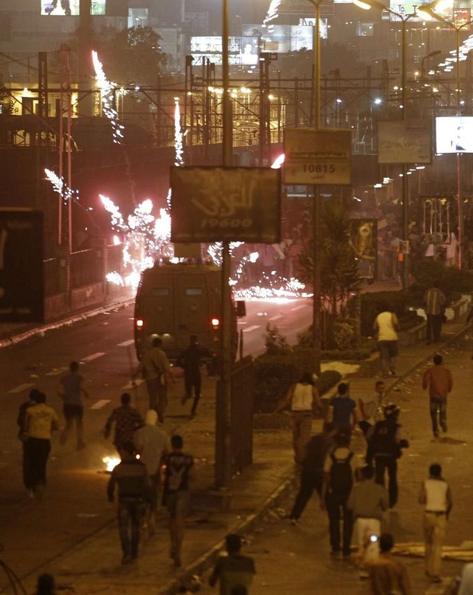 The Muslim Brotherhood and supporters of ousted Egyptian President Mohamed Mursi fire flares and stones at anti-Mursi protesters and riot police during clashes along a road at The Ramsis square which leads to Tahrir Square during a celebration commemorating Egypt's 1973 war with Israel in Cairo October 6, 2013. At least 28 people were killed and more than 90 wounded in clashes during protests in Egypt on Sunday, security sources and state media said, as the crisis since the army seized power three months ago showed no sign of abating.