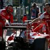 Mechanics push the car of Ferrari Formula One driver Raikkonen of Finland back into the garage during the second practice session of the Australian F1 Grand Prix in Melbourne