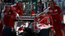 Mechanics push the car of Ferrari Formula One driver Kimi Raikkonen of Finland back into the garage during the second practice session of the Australian F1 Grand Prix at