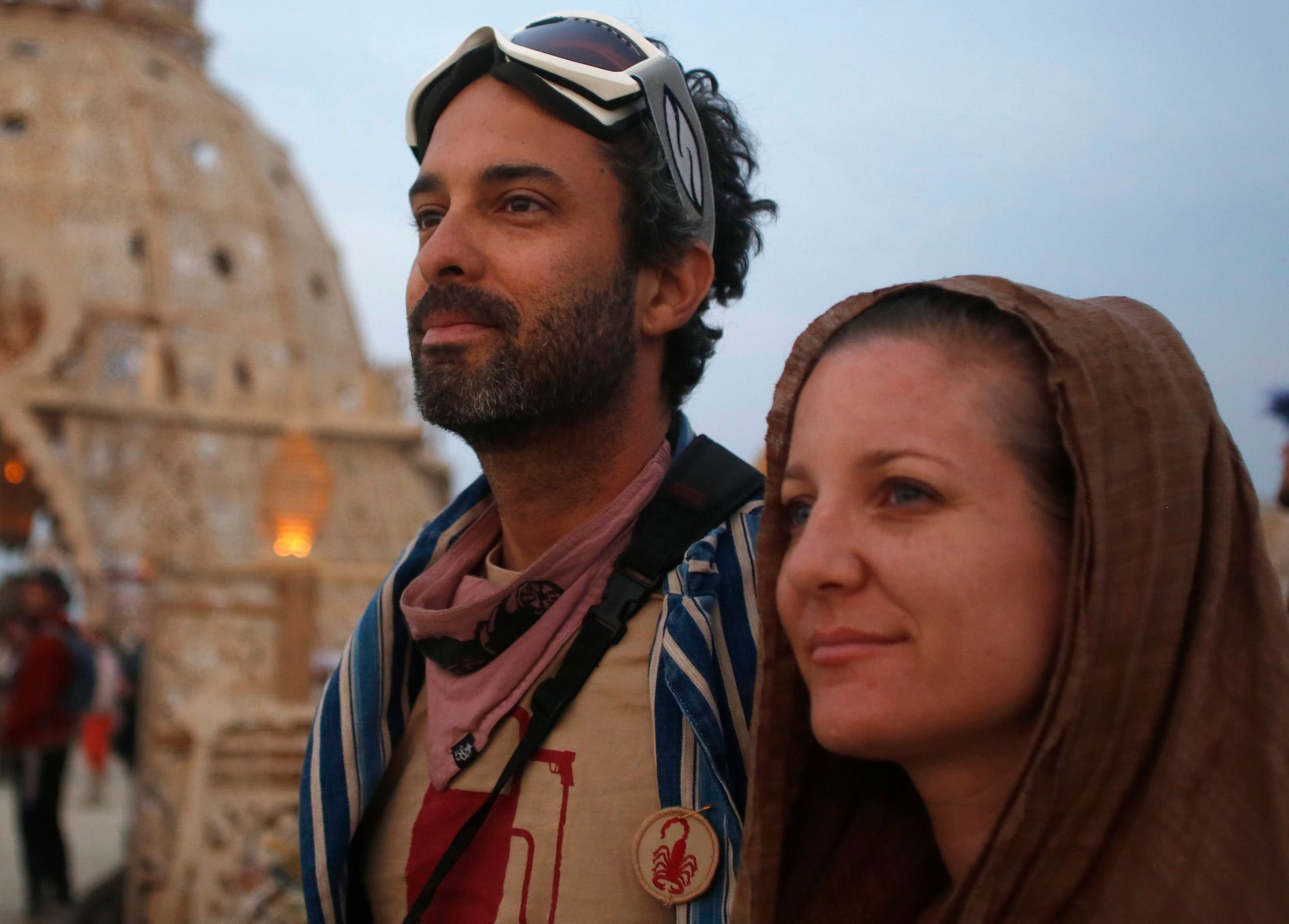 Dan Parras, left, and Melissa Bauman wait for the sun to rise at the Temple of Grace during the Burning Man 2014 &quot;Caravansary&quot; arts and music festival in the Black Rock Desert of Nevada