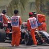Lotus Formula One driver Grosjean of France is driven back to pits after leaving his car during the second practice session of the Malaysian F1 Grand Prix at Sepang International Circuit outside Kuala