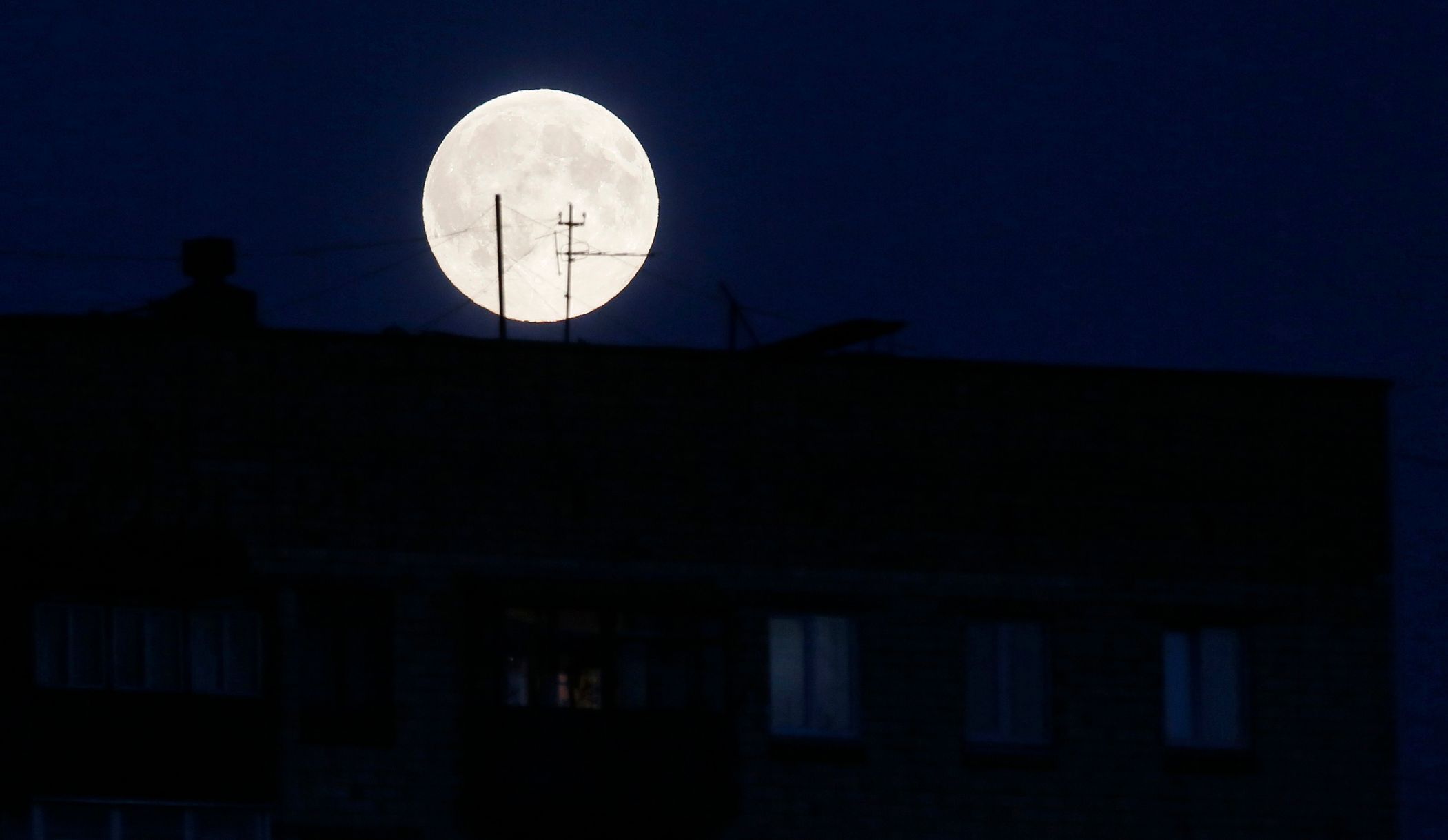 Supermoon is seen behind a residential block of flats in Russia's Siberian city of Krasnoyarsk