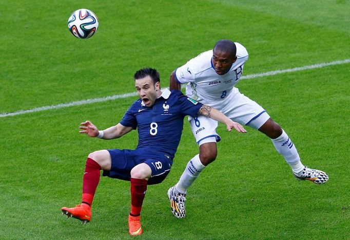 France's Mathieu Valbuena (L) falls beside Wilson Palacios of Honduras as they fight for the ball during their 2014 World Cup Group E soccer match at the Beira Rio stadiu