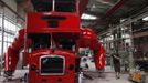 Artist David Cerny gestures at a factory hall in Prague as he works on his project to transform a London bus into a robotic sculpture June 25, 2012. The bus, which Cerny hopes could become an unofficial mascot of the London 2012 Olympic Games, does push-ups with the help of an engine powering a pair of robotic arms and the motion is accompanied by a recording of sounds evoking tough physical effort. It will be parked outside the Czech Olympic headquarters in London for the duration of the Games. Picture taken June 25, 2012. REUTERS/David W Cerny (CZECH REPUBLIC - Tags: SOCIETY SPORT OLYMPICS TRANSPORT) Published: Čec. 22, 2012, 5:57 odp.