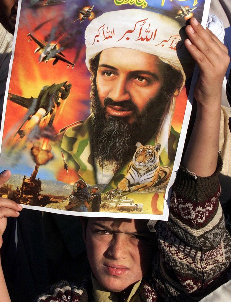 A Pakistani boy holds up a portrait of suspected terrorist Osama bin Laden, leader of the al-Qaeda network, during a demonstration against the US-led invasion of Afghanistan in Rawalpindi, 25 kms west of Islamabad, Rawalpindi, Punjab, Pakistan, November 23, 2001. Hundreds of pro-Taliban demonstrators staged the protest against the United States and the Afghan Northern Alliance.