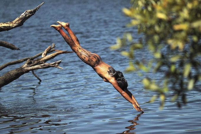 A Yawalapiti girl dives into the Xingu River in the Xingu National Park, Mato Grosso State, May 7, 2012. In August the Yawalapiti tribe will hold the Quarup, which is a ritual held over several days to honour in death a person of great importance to them. This year the Quarup will be honouring two people - a Yawalapiti Indian who they consider a great leader, and Darcy Ribeiro, a well-known author, anthropologist and politician known for focusing on the relationship between native peoples and education in Brazil. Picture taken May 7, 2012. REUTERS/Ueslei Marcelino (BRAZIL - Tags: SOCIETY ENVIRONMENT) ATTENTION EDITORS - PICTURE 05 OF 28 FOR PACKAGE 'LIFE WITH THE YAWALAPITI TRIBE' TEMPLATE OUT Published: Kvě. 15, 2012, 5:09 odp.