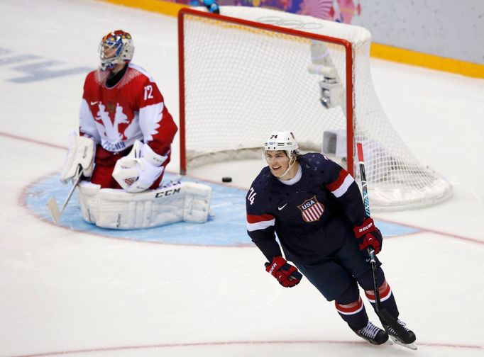 Team USA's T.J. Oshie (R) reacts after scoring the game-winning shootout goal against Russia's goalie Sergei Bobrovski during their men's preliminary round ice hockey gam