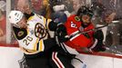 Boston Bruins' Daniel Paille (L) checks Chicago Blackhawks' Johnny Oduya during the first period in Game 1 of their NHL Stanley Cup Finals hockey game in Chicago, Illinoi