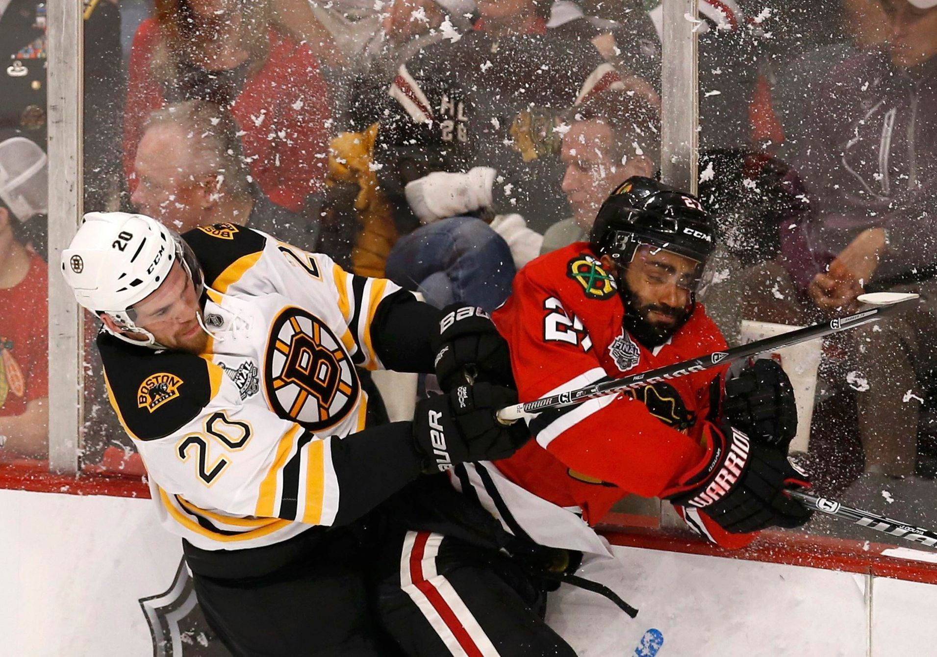 Bruins' Paille checks Blackhawks' Oduya during the first per