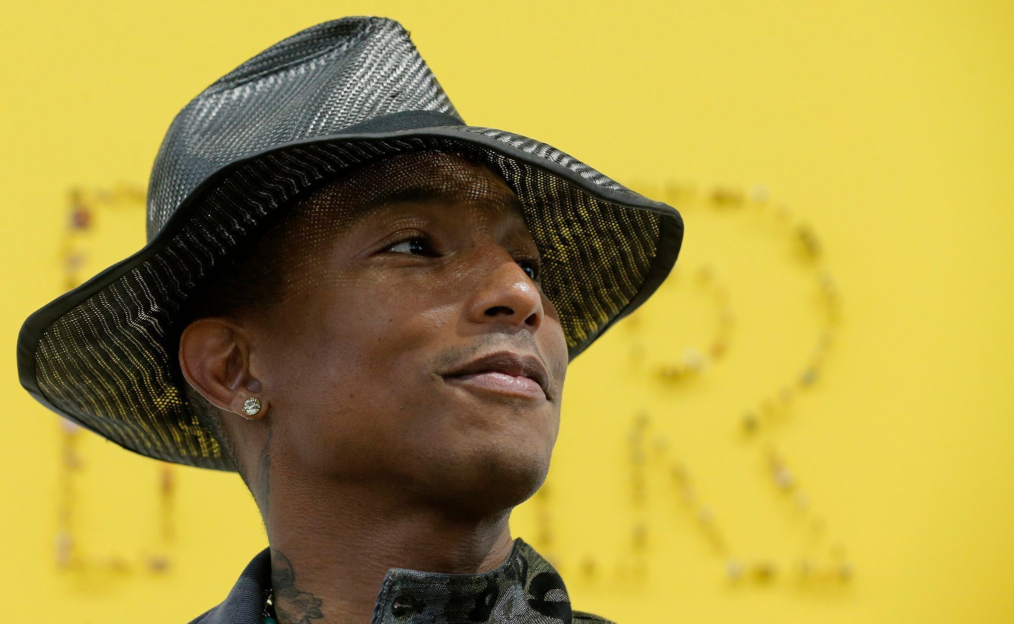 Singer Pharrell Williams poses during the opening of the exhibition &quot;GIRL&quot; at the Galerie Perrotin in Paris
