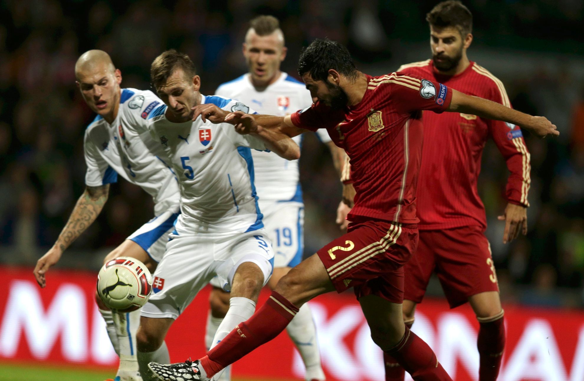 Albiol of Spain challenges Gyomber of Slovakia during their Euro 2016 qualification soccer match at the MSK stadium in Zilina