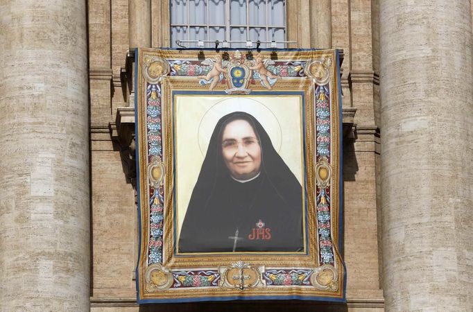 The tapestry of Maria Guadalupe Garcia Zavala hangs on Saint Peter's Basilica during a canonization mass led by Pope Francis at the Vatican May 12, 2013. The Pope leads a mass on Sunday for Antonio Primaldo, mother Laura Montoya and Maria Guadalupe Garcia Zavala.