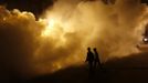 Men walk amid the smoke of an anti-mosquito gas near the banks of river Ganges ahead of the "Kumbh Mela" (Pitcher Festival) in the northern Indian city of Allahabad January 11, 2013. During the festival, Hindus take part in a religious gathering on the banks of the river Ganges. "Kumbh Mela" will return to Allahabad in 12 years. REUTERS/Ahmad Masood (INDIA - Tags: RELIGION SOCIETY) Published: Led. 11, 2013, 6:19 odp.