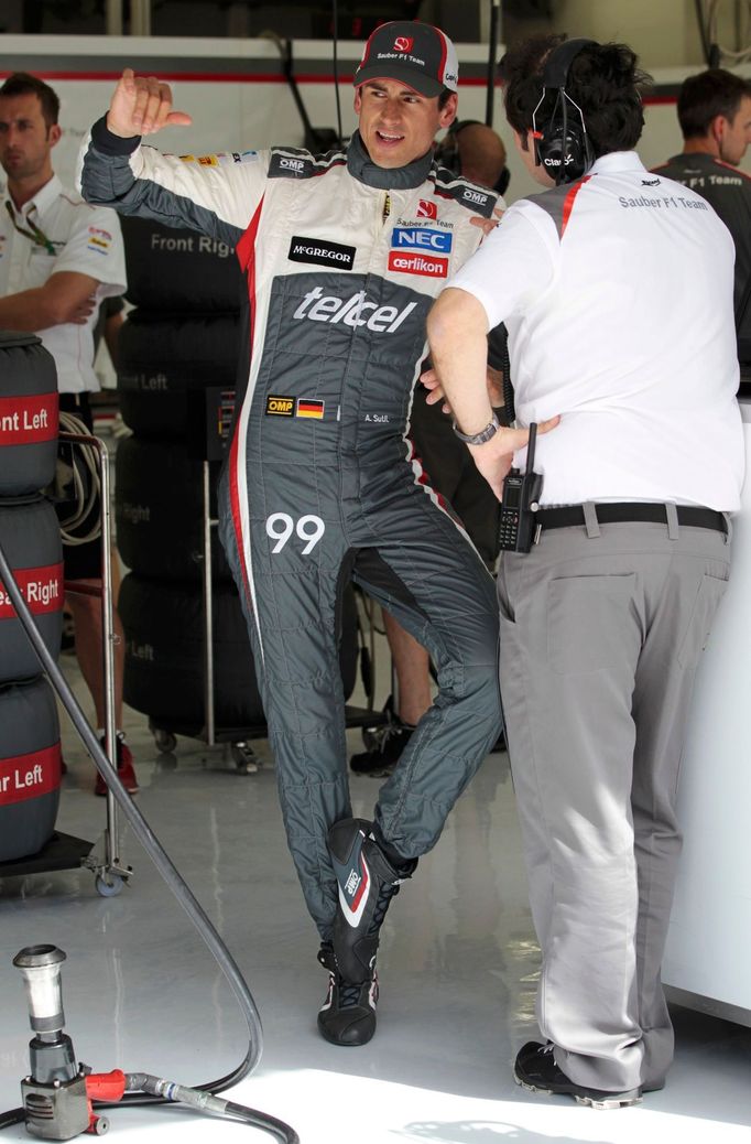 Sauber Formula One driver Adrian Sutil of Germany gestures as he speaks to a crew member during the first practice session of the Bahrain F1 Grand Prix at the Bahrain Int