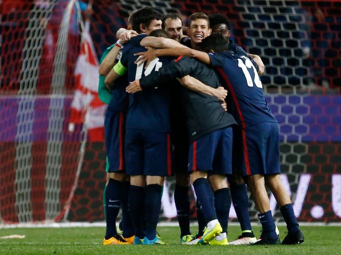 Atletico players celebrate at the end of the game