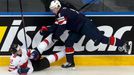 Jacob Trouba of the U.S. (R) pushes Switzerland's Luca Cunti (L) during the first period of their men's ice hockey World Championship group B game at Minsk Arena in Minsk