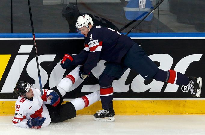 Jacob Trouba of the U.S. (R) pushes Switzerland's Luca Cunti (L) during the first period of their men's ice hockey World Championship group B game at Minsk Arena in Minsk