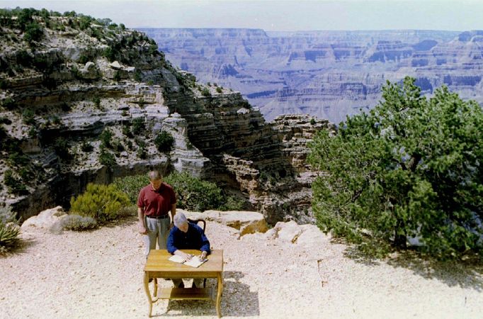 President Clinton (seated) signs into law the creation of the Grand Staircase-Escalante National Monument as Vice President Al Gore watches.