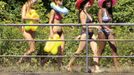 Women wearing bikinis walk along the Limmat river during hot sunny summer weather in Zurich August 18, 2012. The Federal Office of Meteorology MeteoSwiss has launched a warning for a heat wave for the weekend until Wednesday August 22. REUTERS/Arnd Wiegmann (SWITZERLAND - Tags: ENVIRONMENT SOCIETY) Published: Srp. 18, 2012, 2:29 odp.